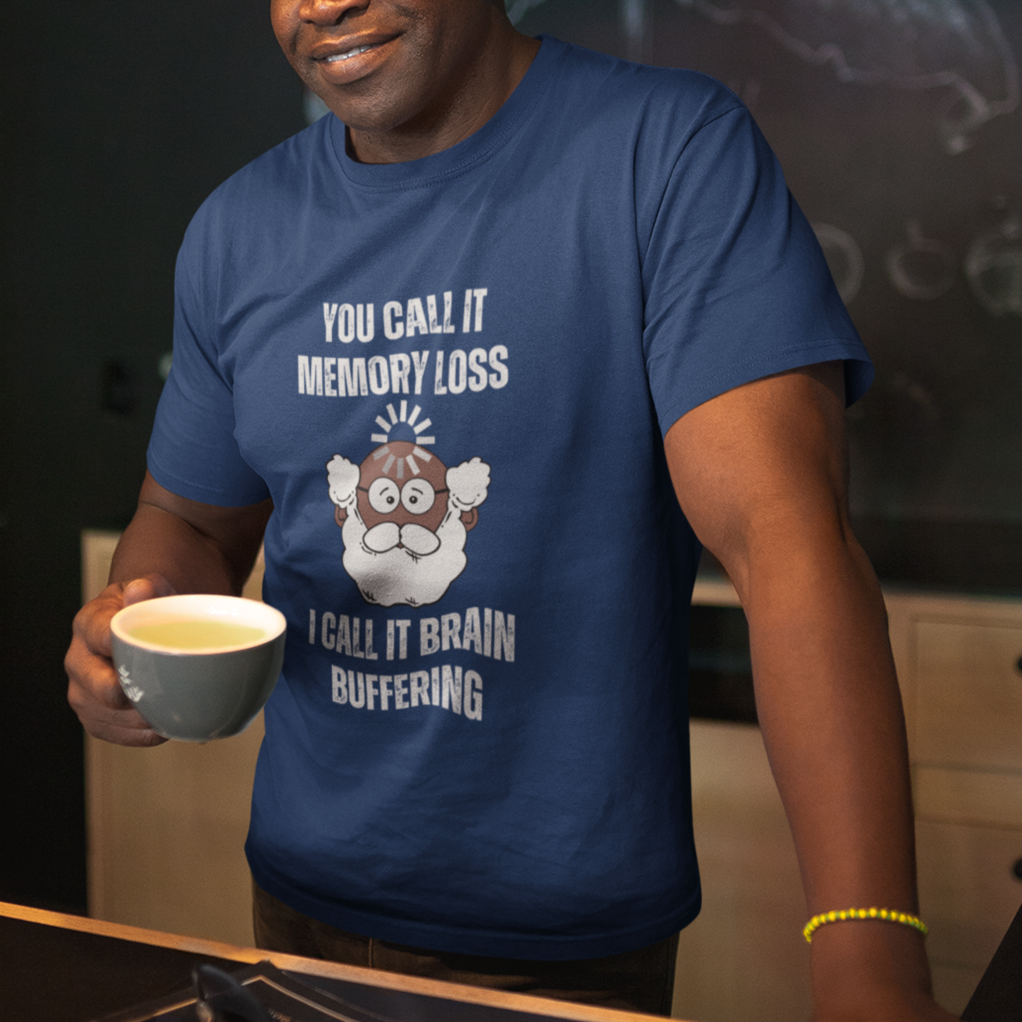 Navy blue t-shirt featuring the phrase 'Brain Buffering' with a loading icon graphic and a bald, bearded dark-toned senior.