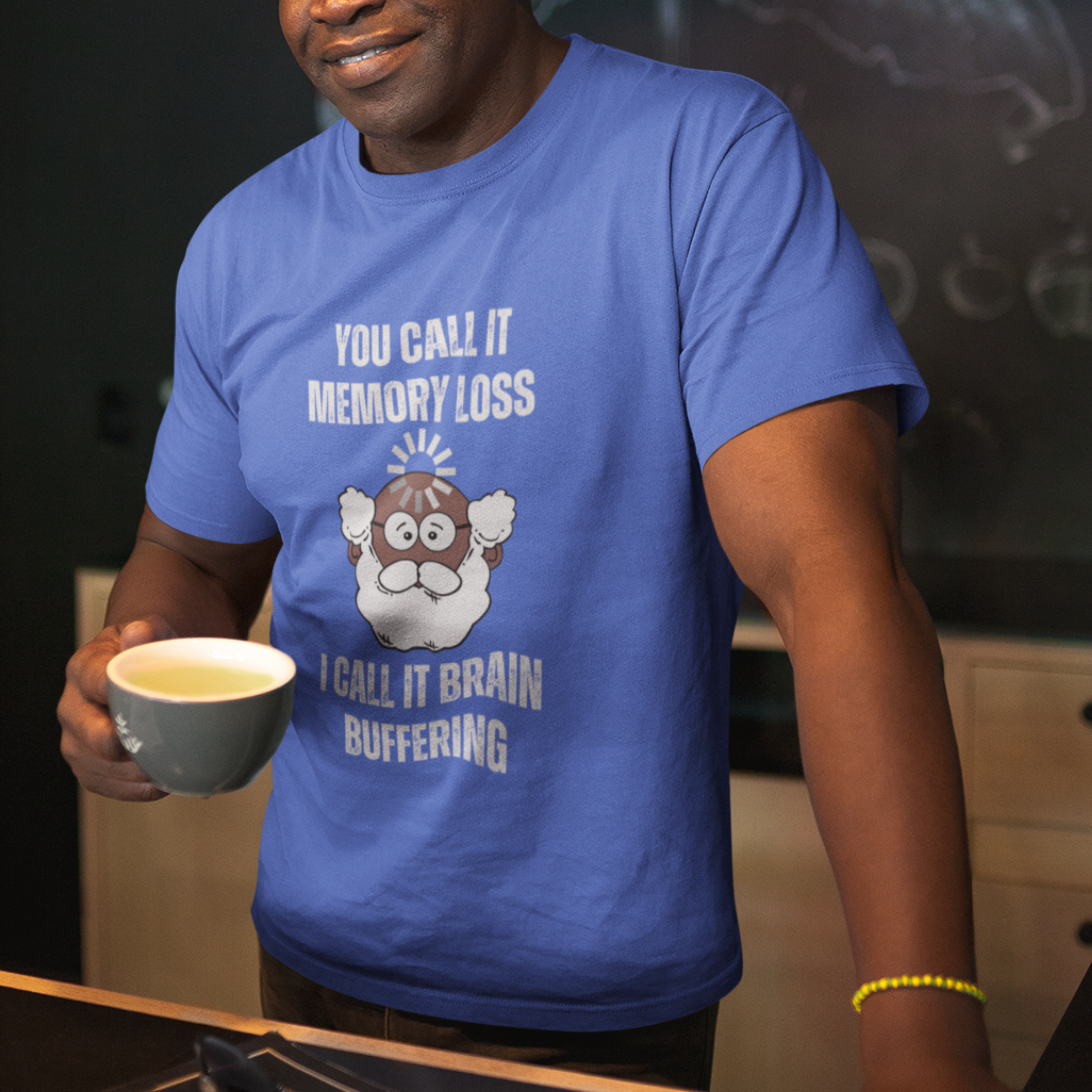 Royal blue t-shirt featuring the phrase 'Brain Buffering' with a loading icon graphic and a bald, bearded dark-toned senior.