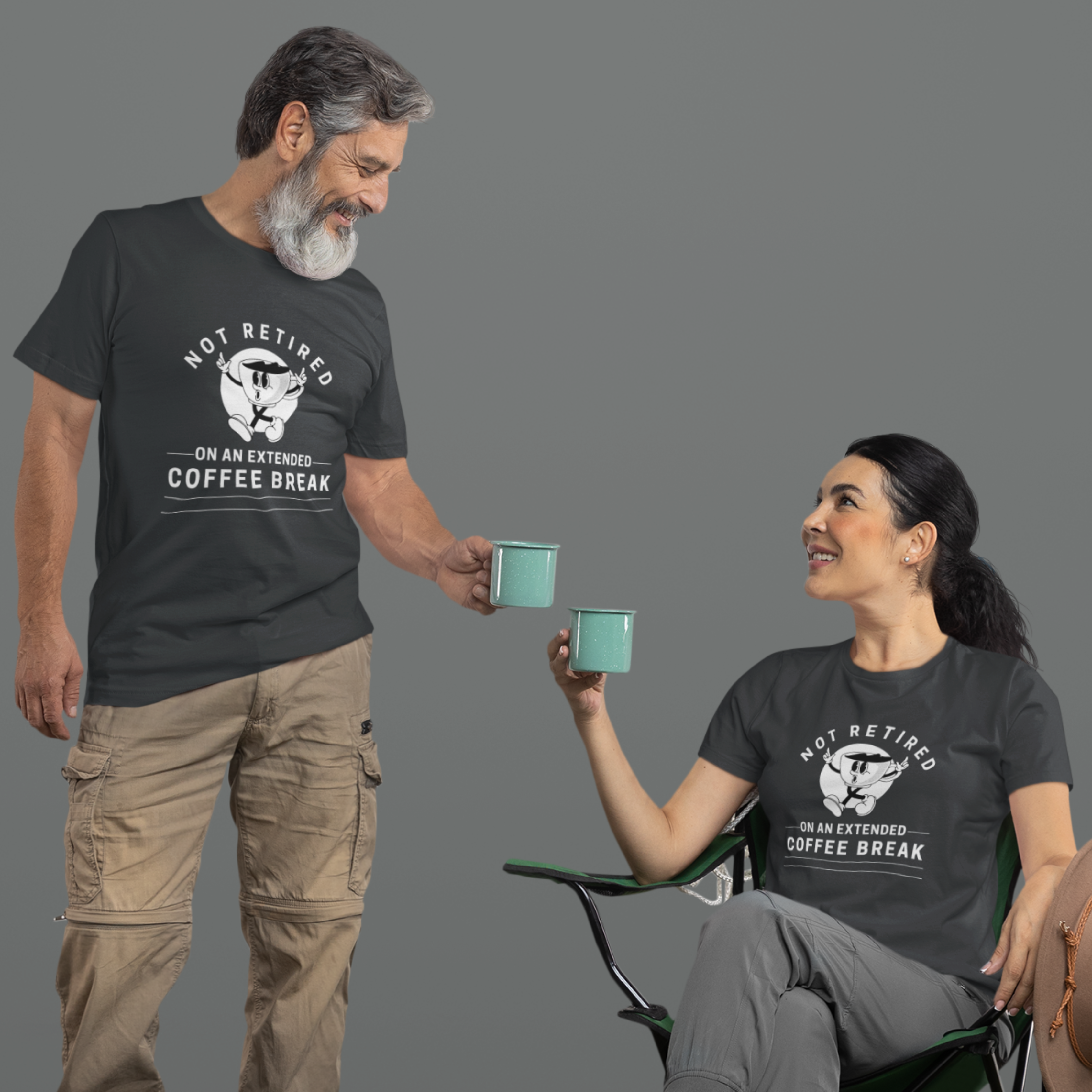 A couple in back t-shirts featuring a whistling cartoon coffee cup that reads, Not Retired On An Extended Coffee Break. 