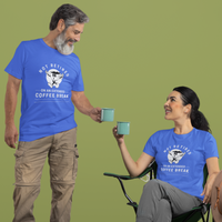 A couple in royal blue t-shirts featuring a whistling cartoon coffee cup that reads, Not Retired On An Extended Coffee Break. 