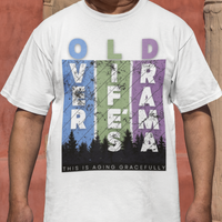 White t-shirt featuring pastel stripes and lettering with a forest scene in silhouette, stating Over Life's Drama This is Aging Gracefully