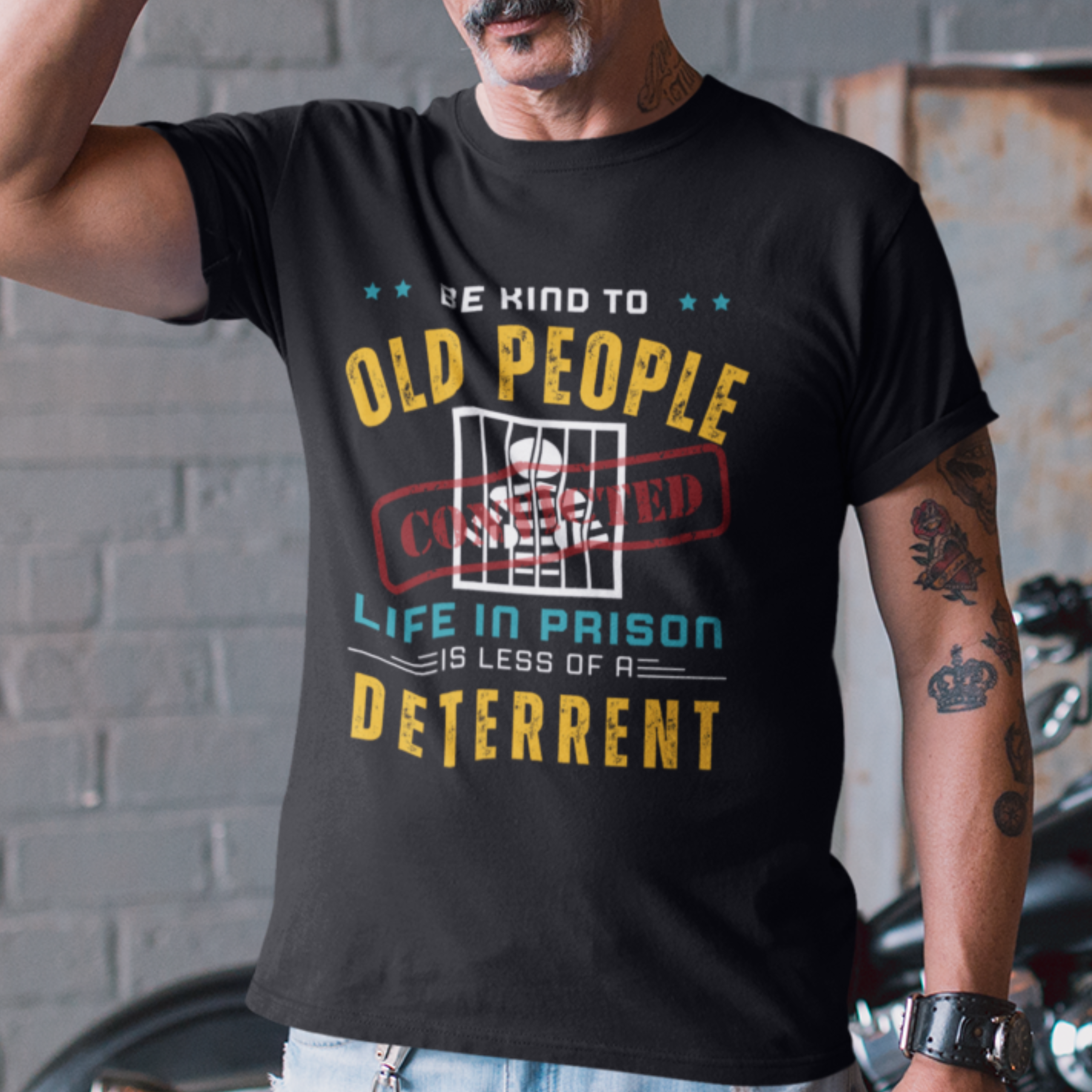 Black t-shirt that reads Be Kind to Old People Life in Prison is Less of a Deterrent and features a prisoner behind bars pictogram.