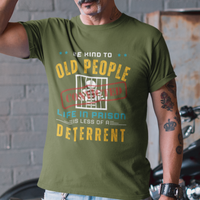 Military green t-shirt that reads Be Kind to Old People Life in Prison is Less of a Deterrent and features a prisoner behind bars pictogram.