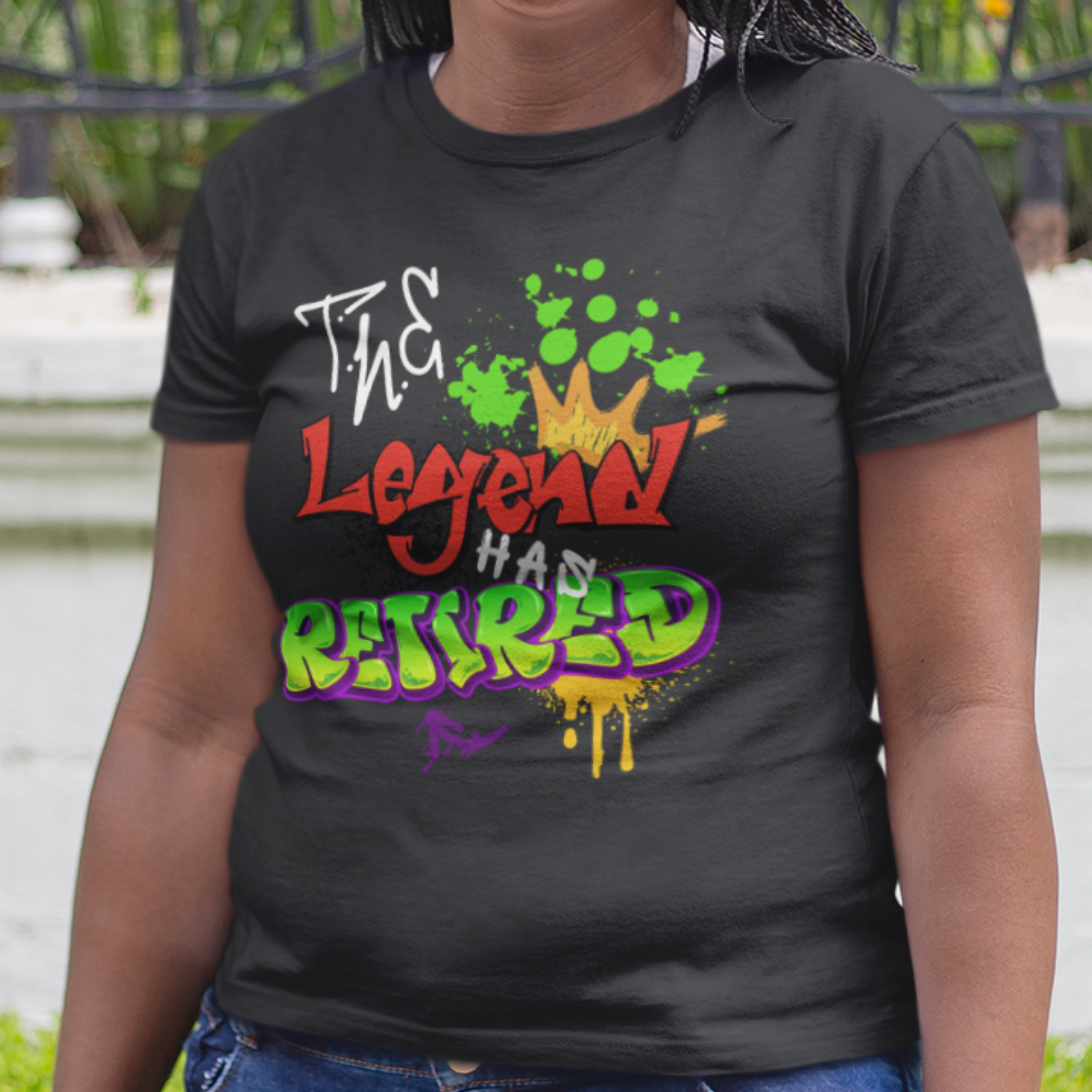 Black t-shirt featuring bold graffiti style fonts states "The Legend Has Retired"