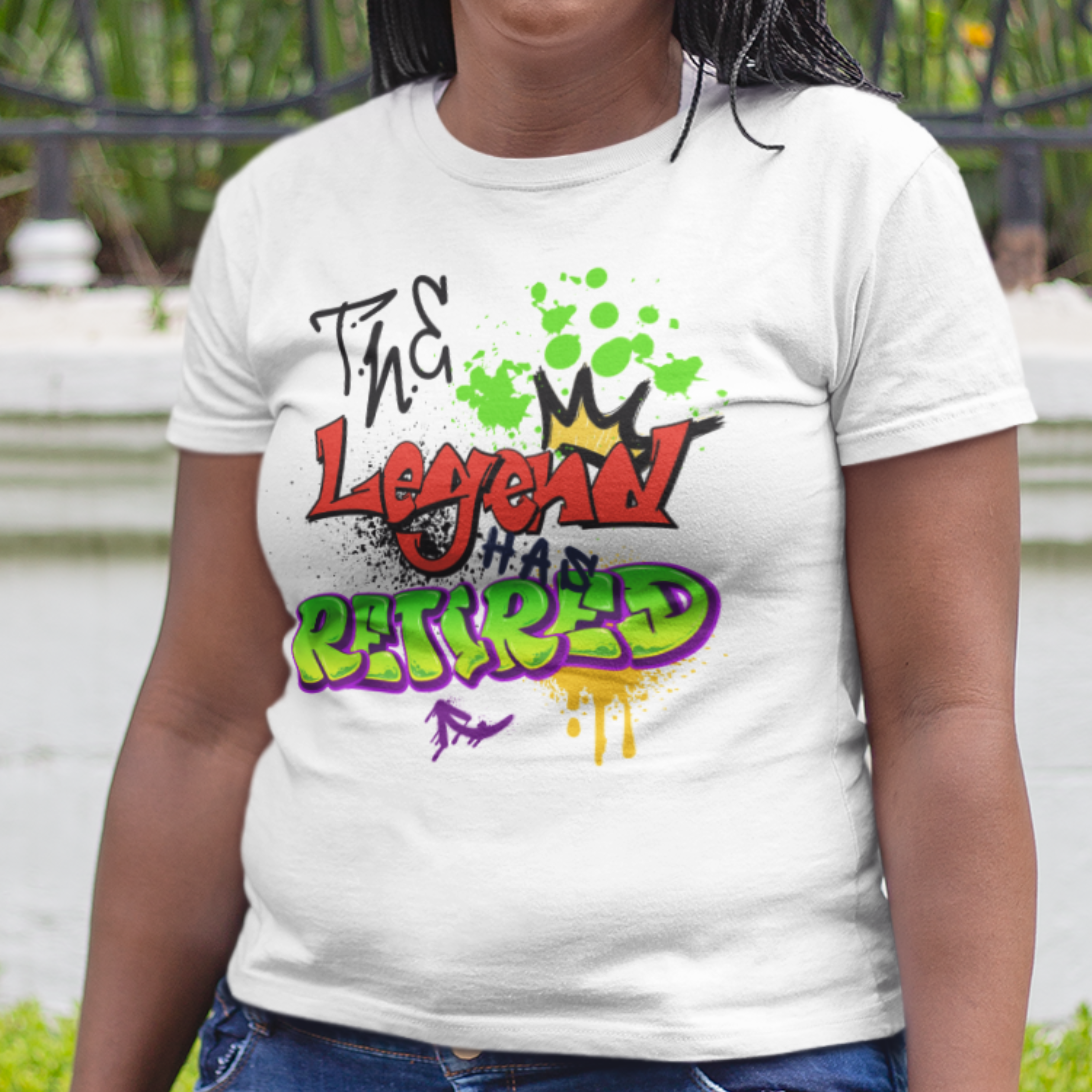 White t-shirt featuring bold graffiti style fonts states "The Legend Has Retired"