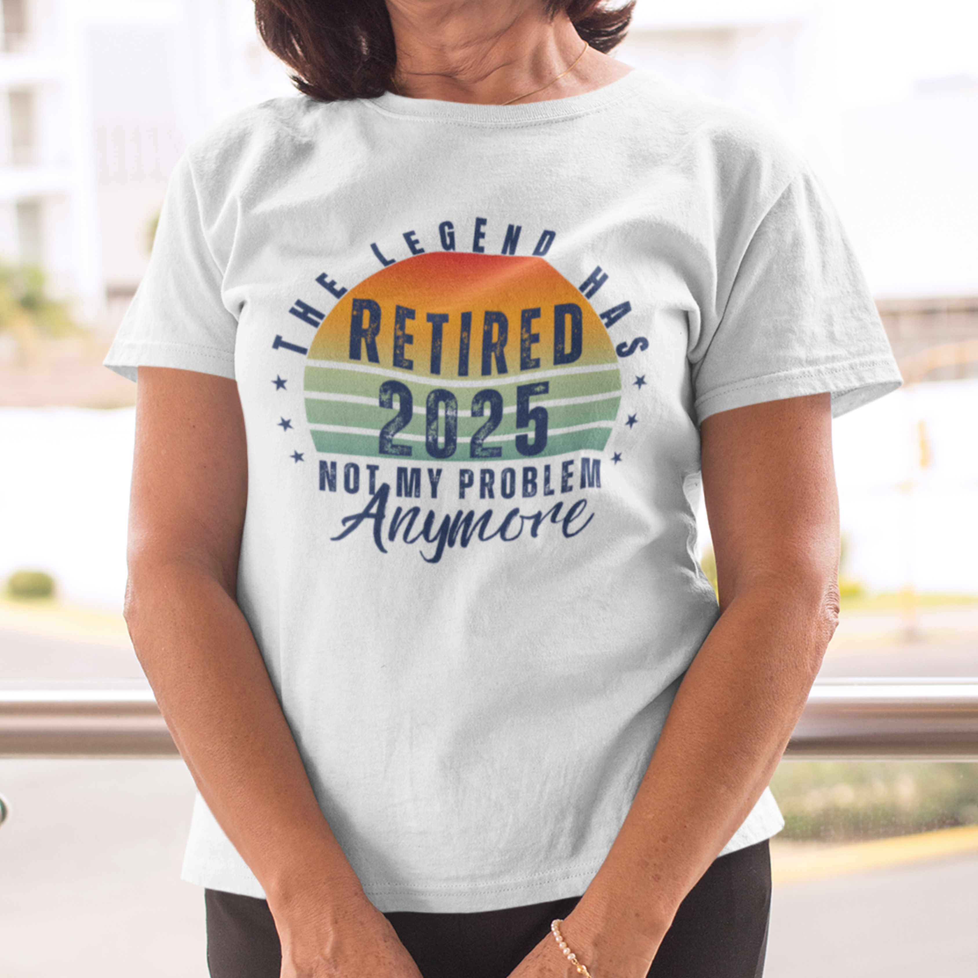 White t-shirt featuring a striped sunset that reads The Legend Has Retired Not My Problem Anymore
