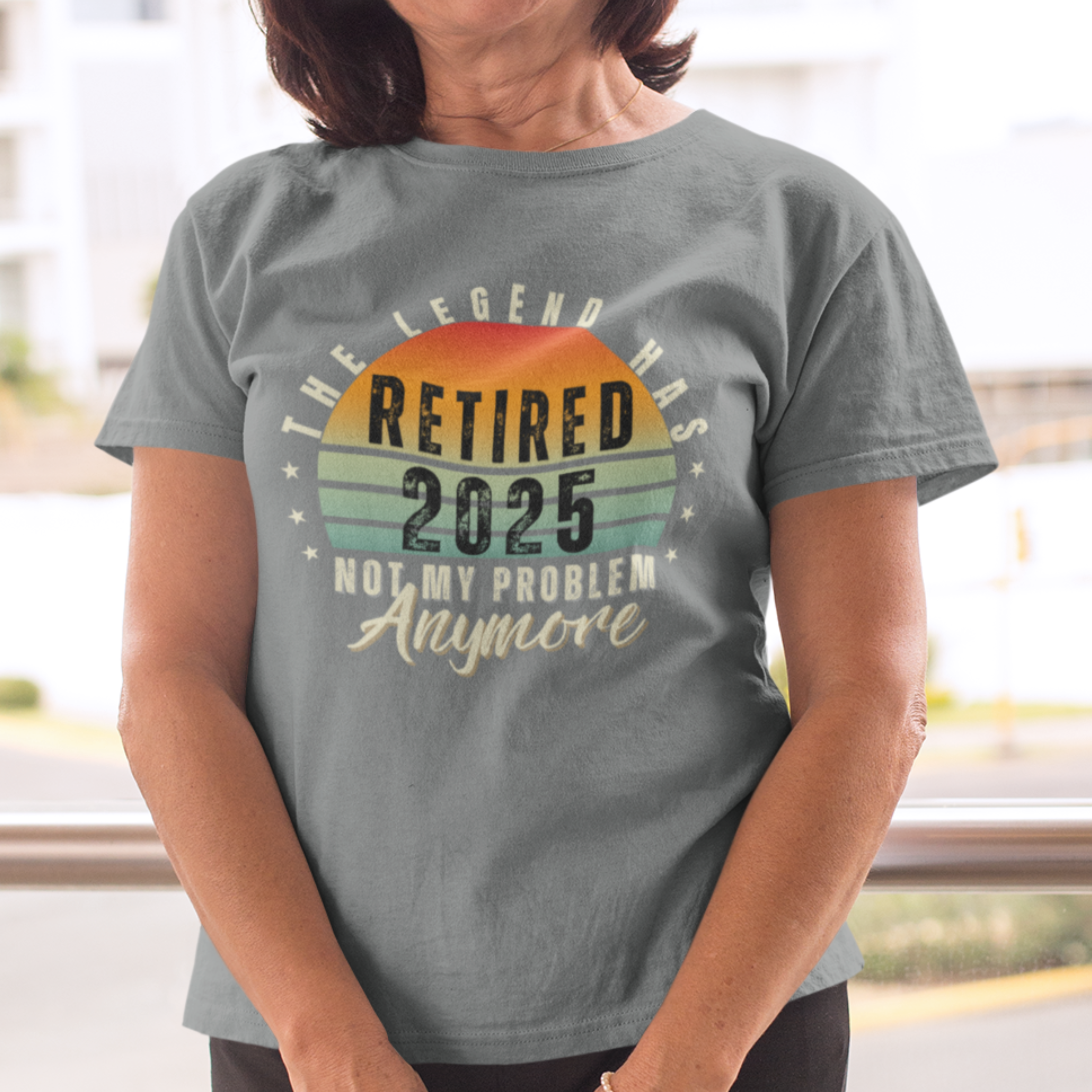 Gray t-shirt featuring a striped sunset that reads The Legend Has Retired Not My Problem Anymore