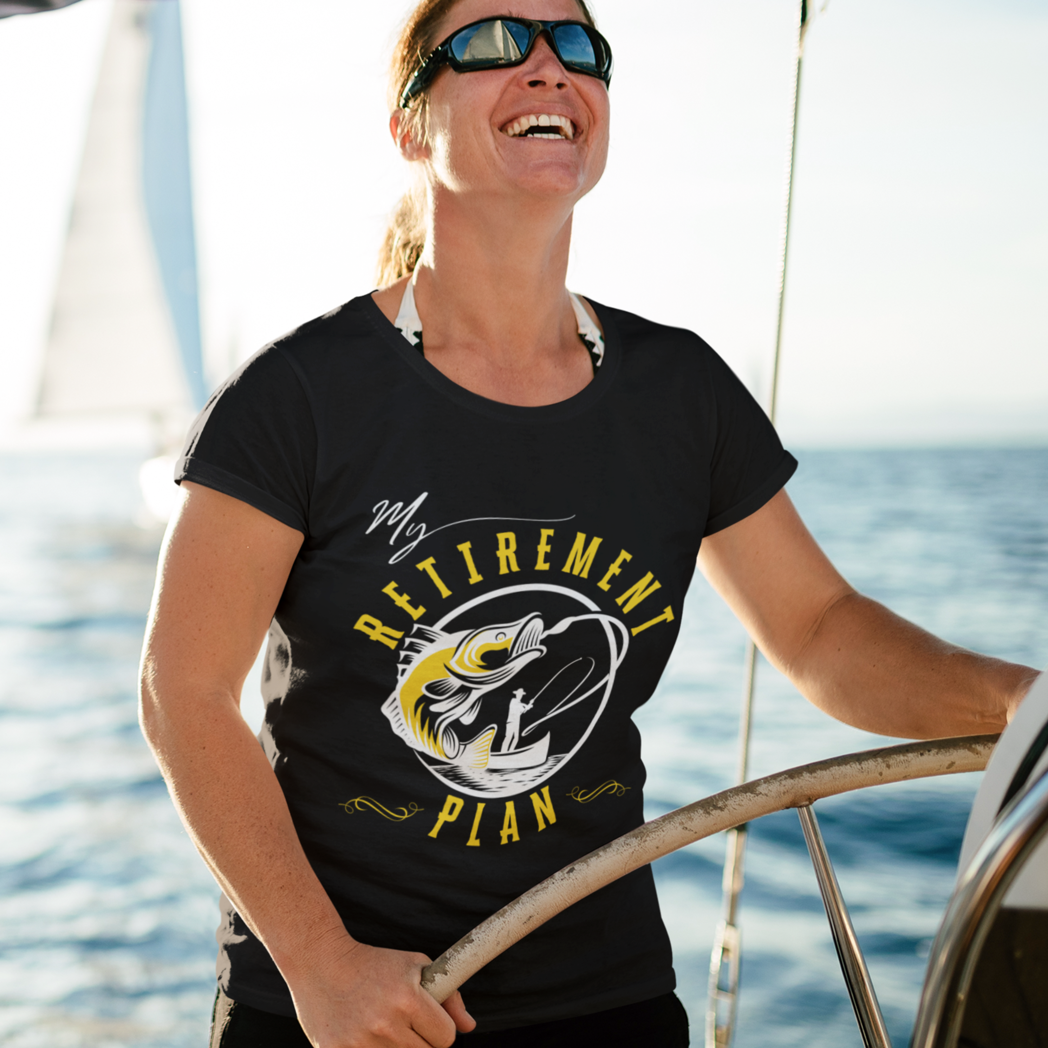 Black t-shirt featuring a fisherman hooking a big bass on a fishing line. 