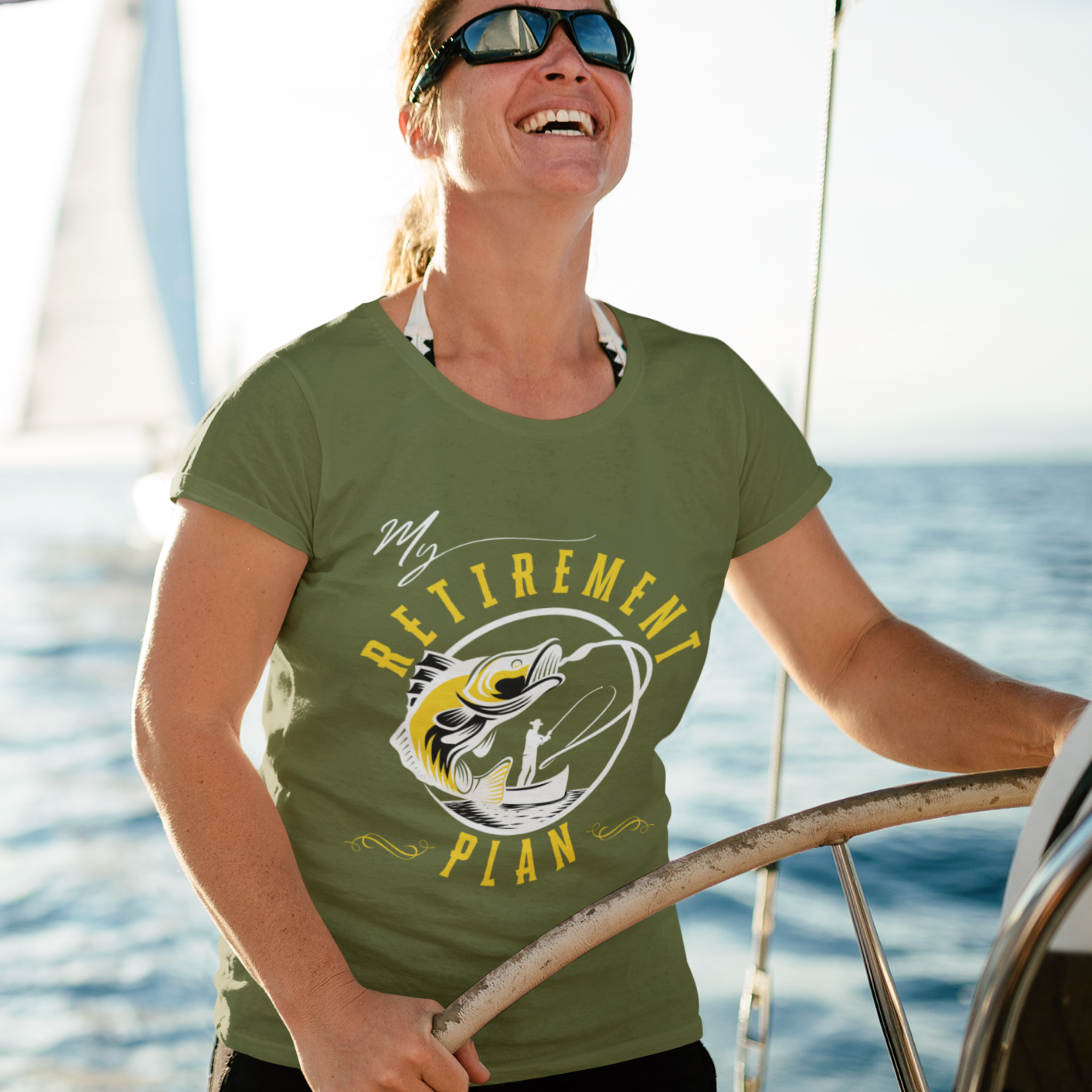 Military green t-shirt featuring a fisherman hooking a big bass on a fishing line.