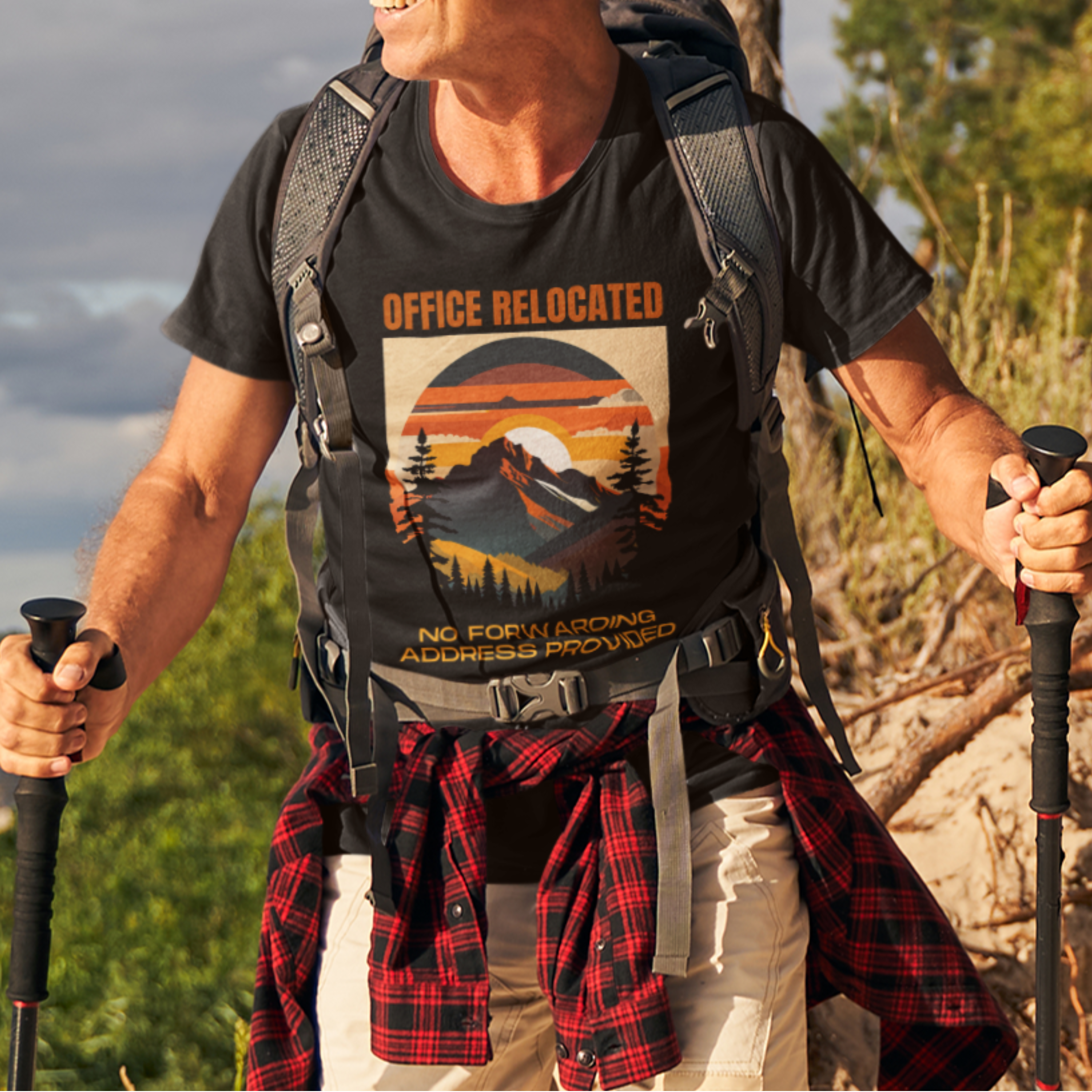 Black tee on a male hiker featuring a mountain peak at sunset in warm colors that reads Office Relocated No Forwarding Address Provided