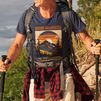 Navy blue tee on a male hiker featuring a mountain peak at sunset in warm colors that reads Office Relocated No Forwarding Address Provided
