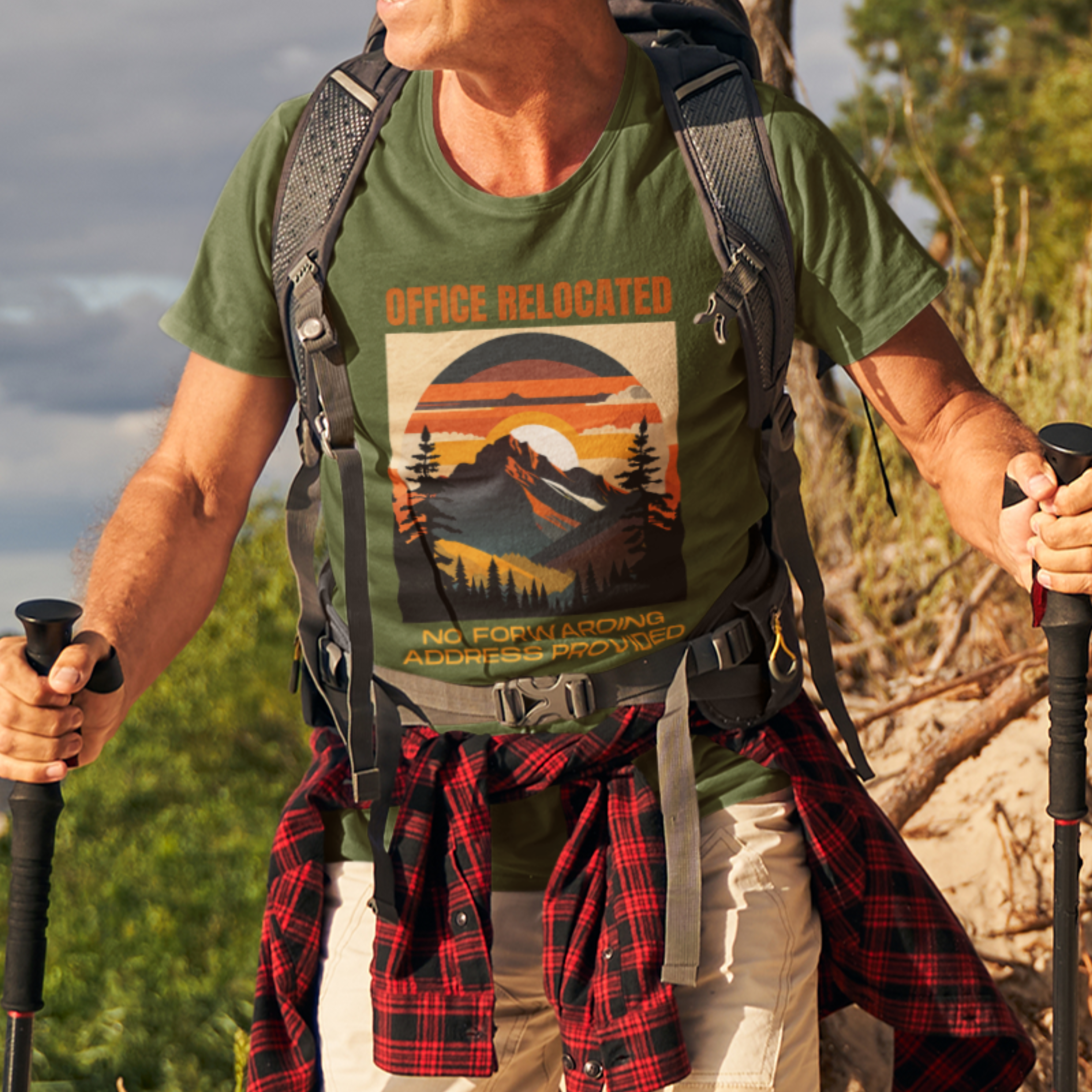 Military green tee on a male hiker featuring a mountain peak at sunset in warm colors that reads Office Relocated No Forwarding Address Provided
