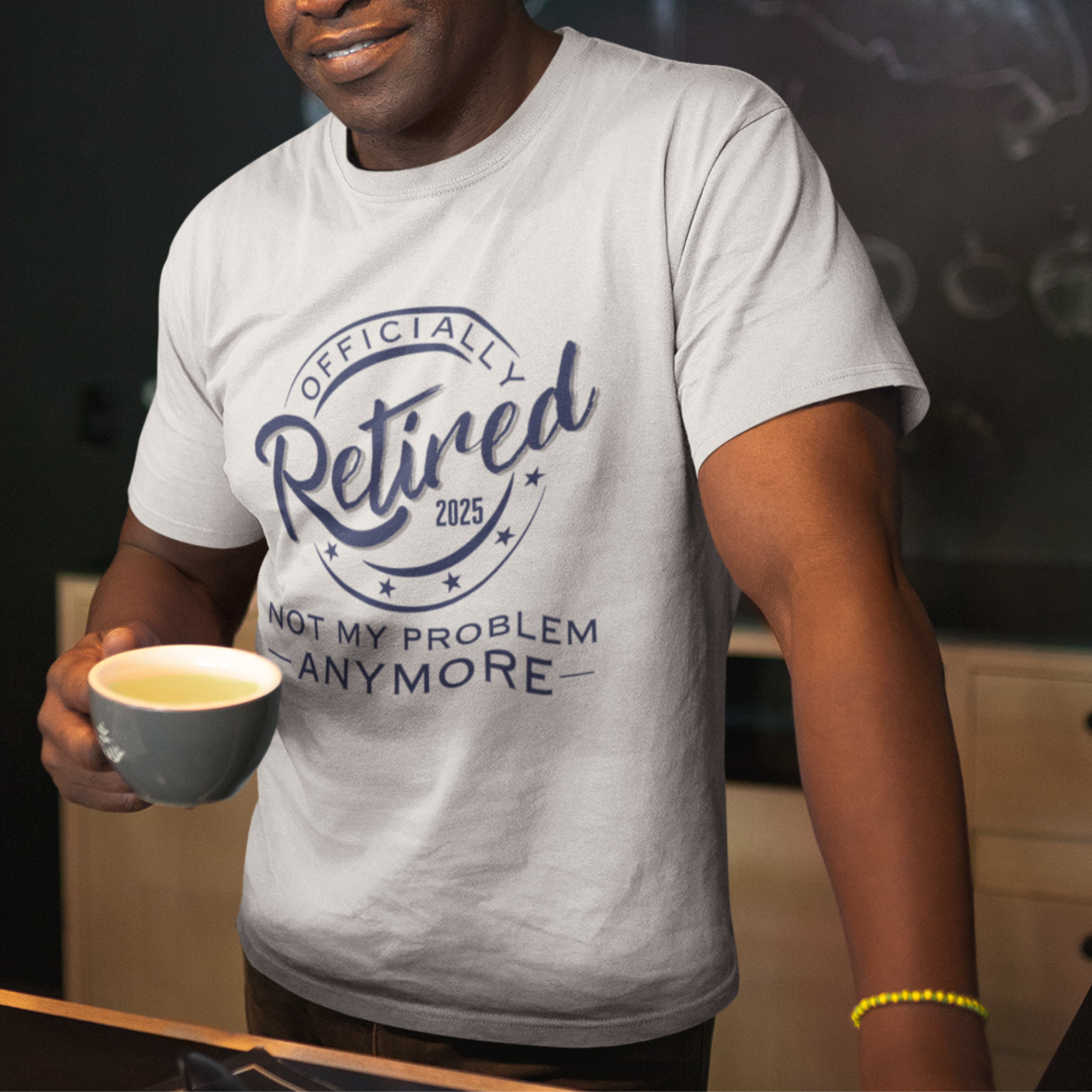 White tee featuring a replica of an official stamp embossing that reads "Officially Retired 2025 Not My Problem Anymore"
