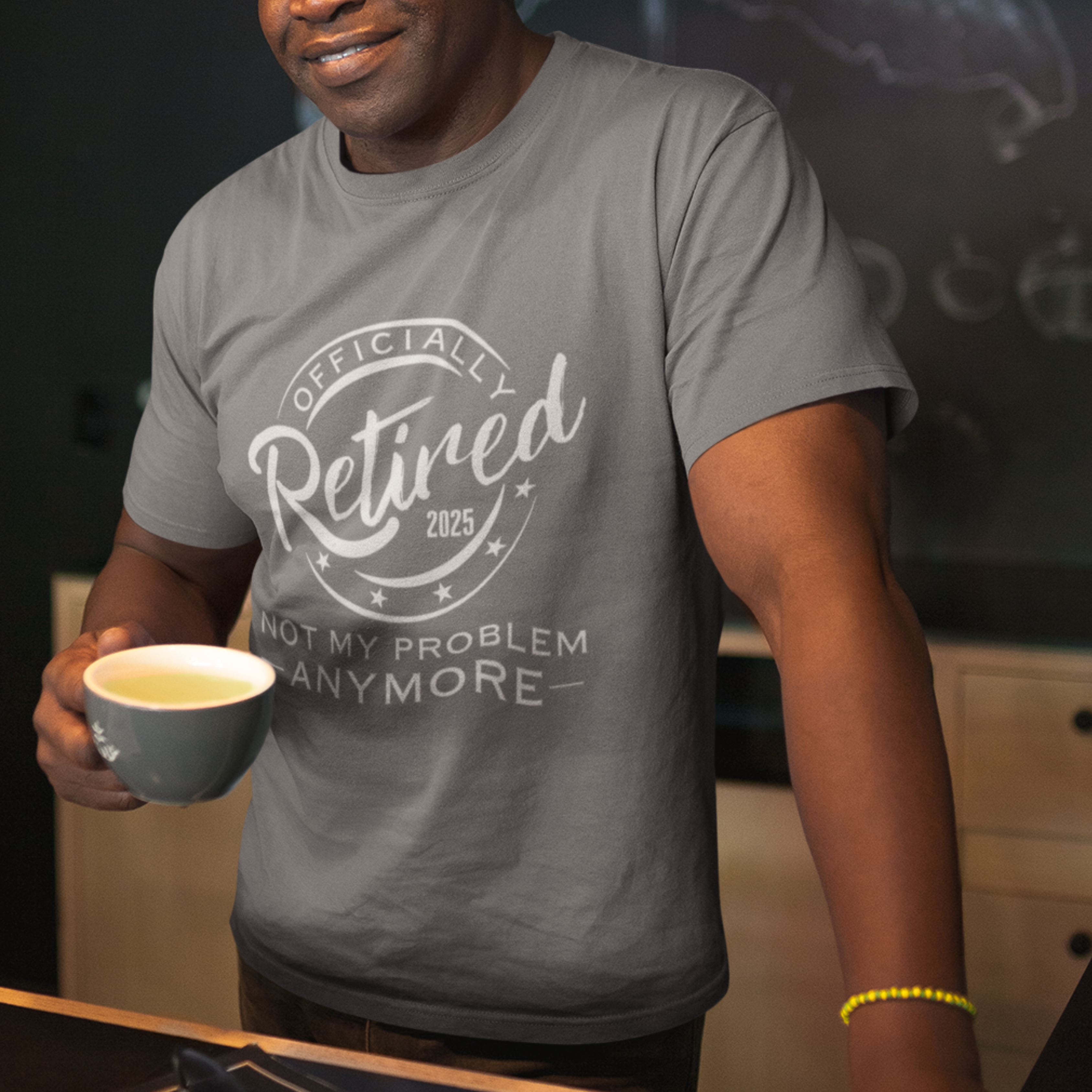 Heather gray tee featuring a replica of an official stamp embossing that reads "Officially Retired 2025 Not My Problem Anymore"
