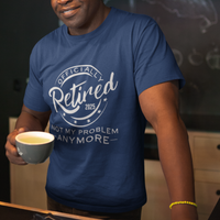 Navy blue tee featuring a replica of an official stamp embossing that reads "Officially Retired 2025 Not My Problem Anymore"

