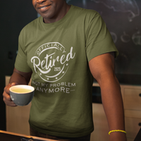 Military green tee featuring a replica of an official stamp embossing that reads "Officially Retired 2025 Not My Problem Anymore"
