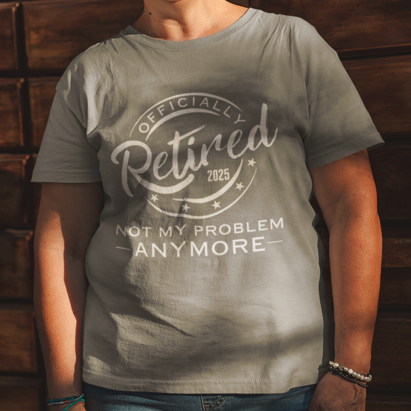 Heather gray tee featuring a replica of an official stamp embossing that reads "Officially Retired 2025 Not My Problem Anymore"