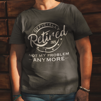 Black tee featuring a replica of an official stamp embossing that reads "Officially Retired 2025 Not My Problem Anymore"