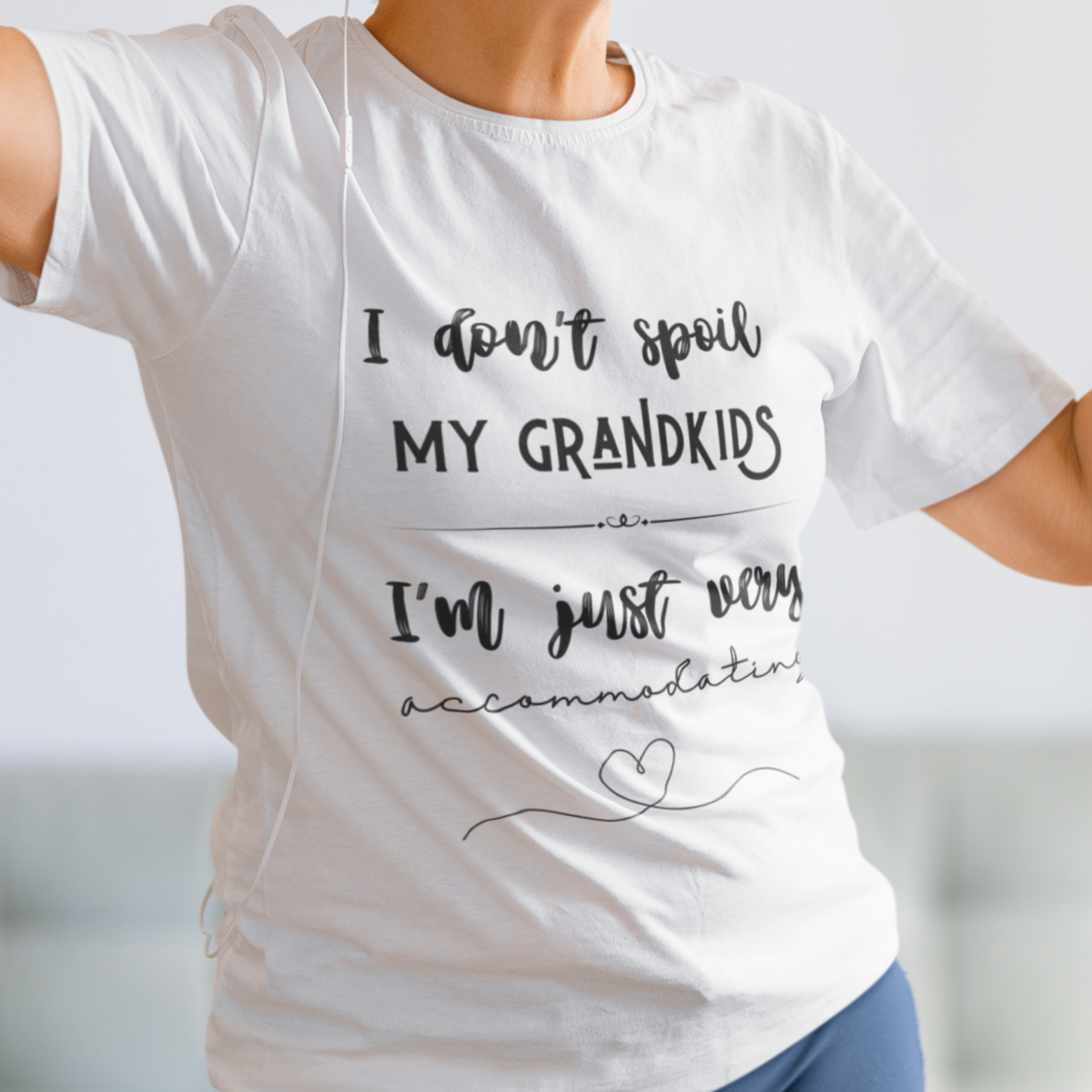 White tee that reads I Don't Spoil My Grandkids, I'm Just Very Accommodating with heart shapes