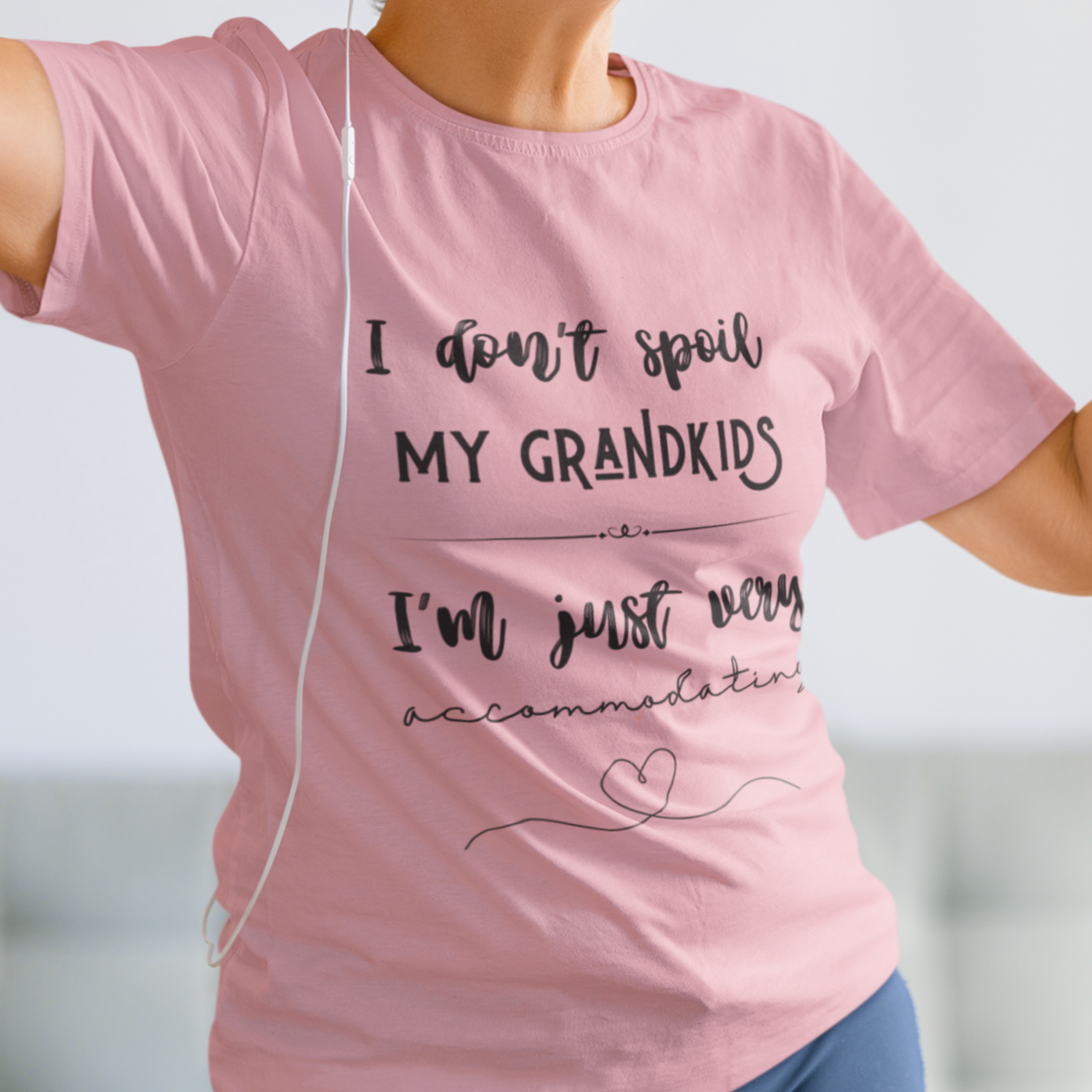 Light pink tee that reads I Don't Spoil My Grandkids, I'm Just Very Accommodating with heart shapes