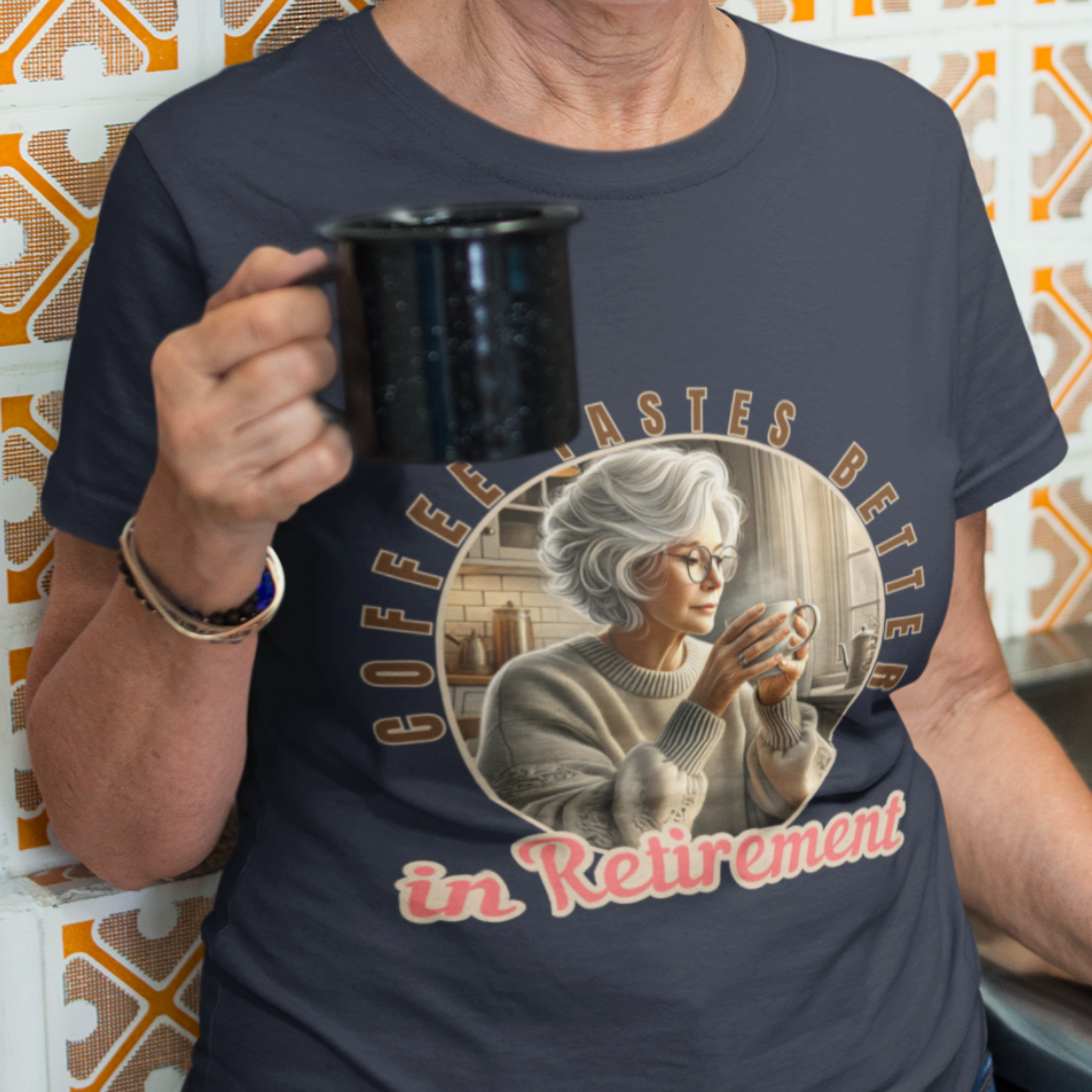 Navy blue tee featuring a senior woman at her kitchen table enjoying a hot cup of coffee.