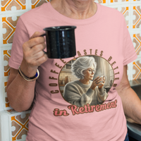 Light pink tee featuring a senior woman at her kitchen table enjoying a hot cup of coffee.