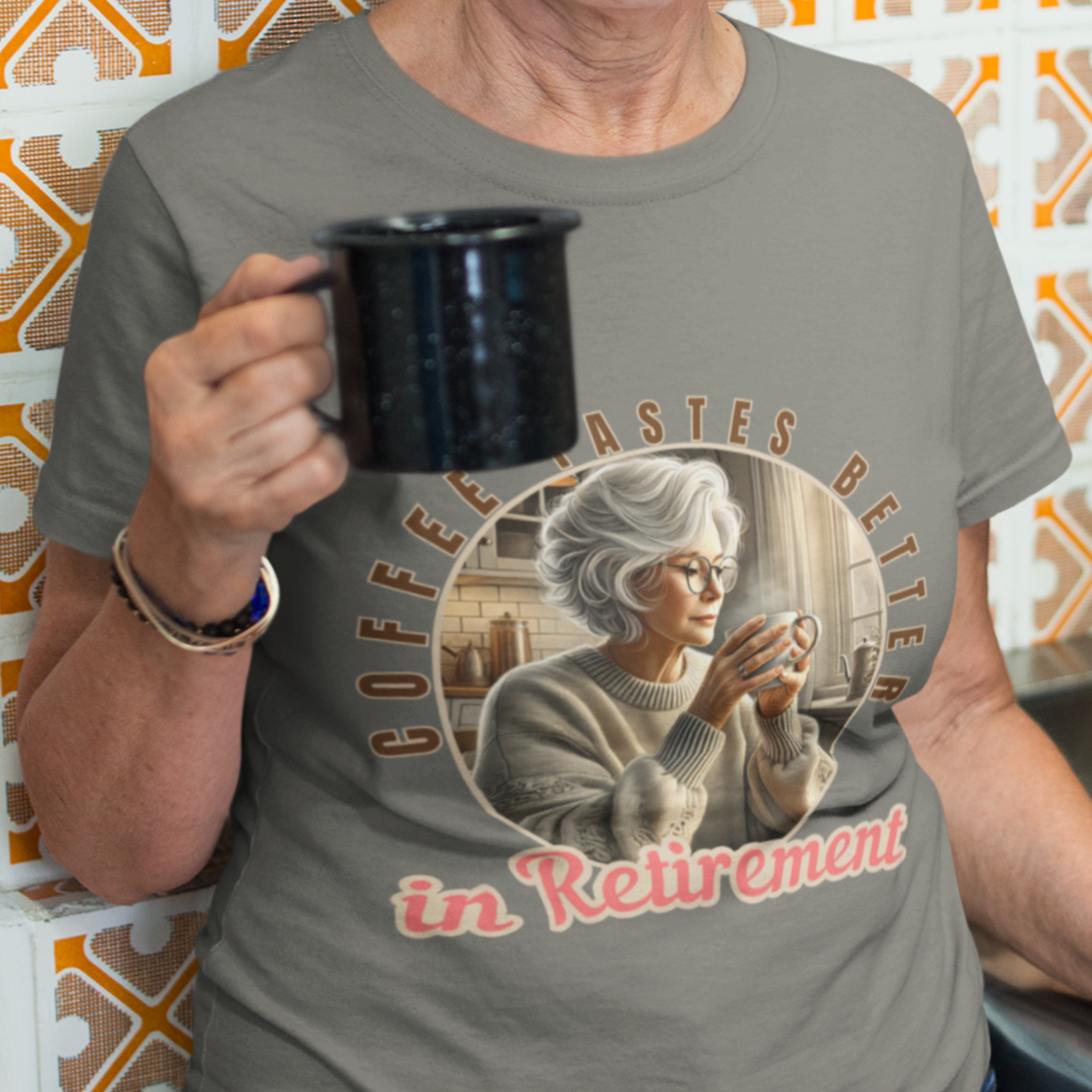 Heather gray tee featuring a senior woman at her kitchen table enjoying a hot cup of coffee.