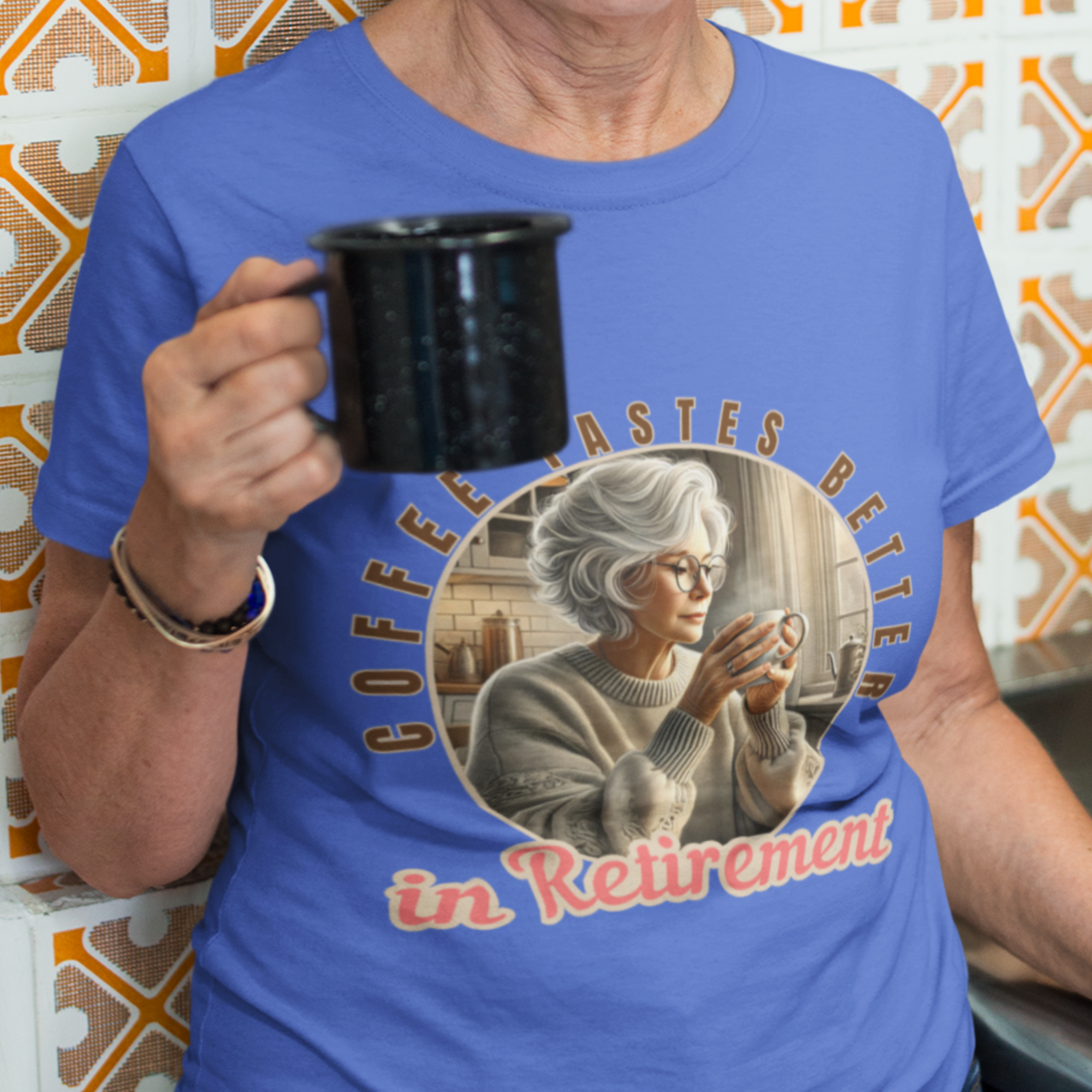 Royal blue tee featuring a senior woman at her kitchen table enjoying a hot cup of coffee.