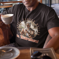 Black tee featuring a senior man at his kitchen table enjoying a hot cup of coffee.