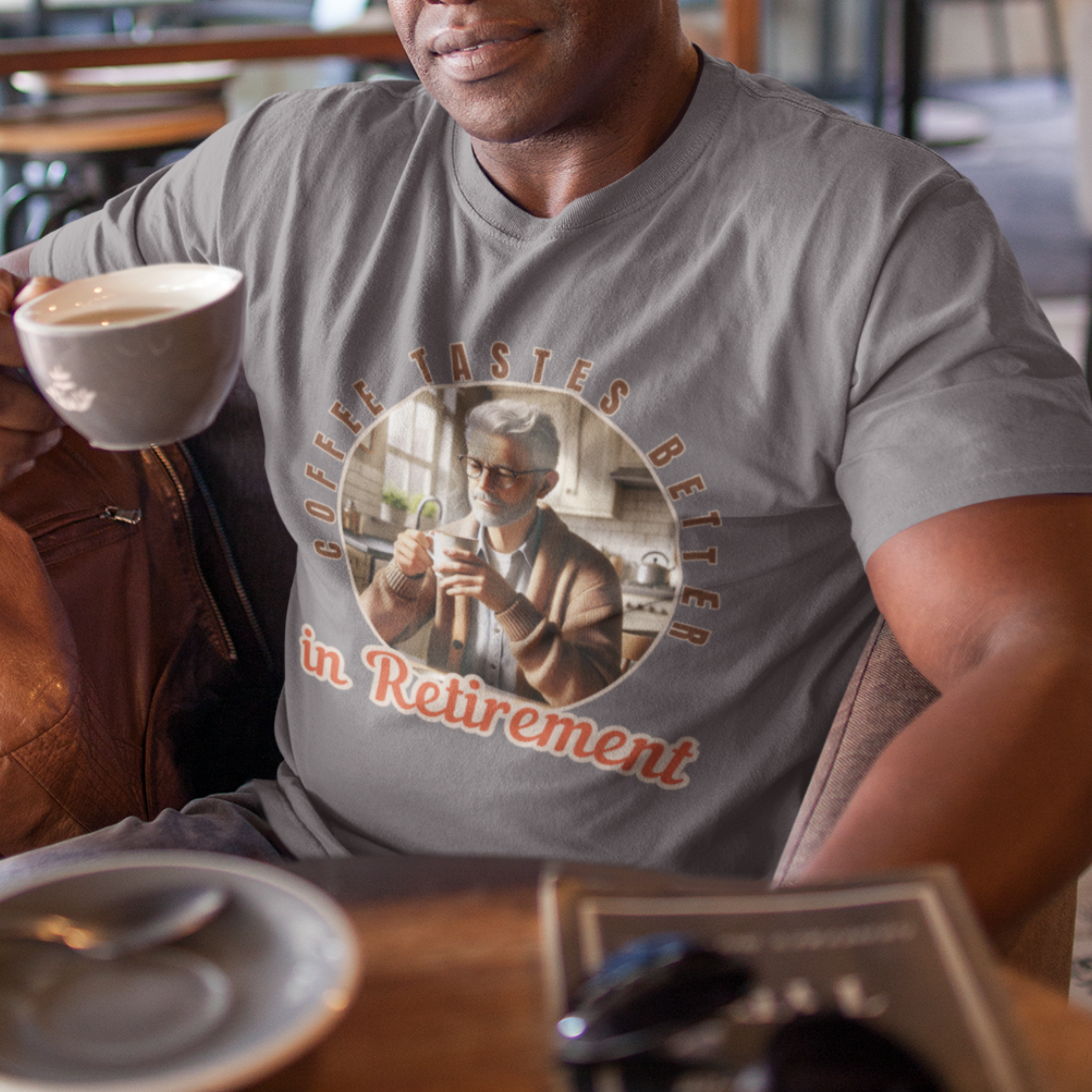 Heather gray tee featuring a senior man at his kitchen table enjoying a hot cup of coffee.