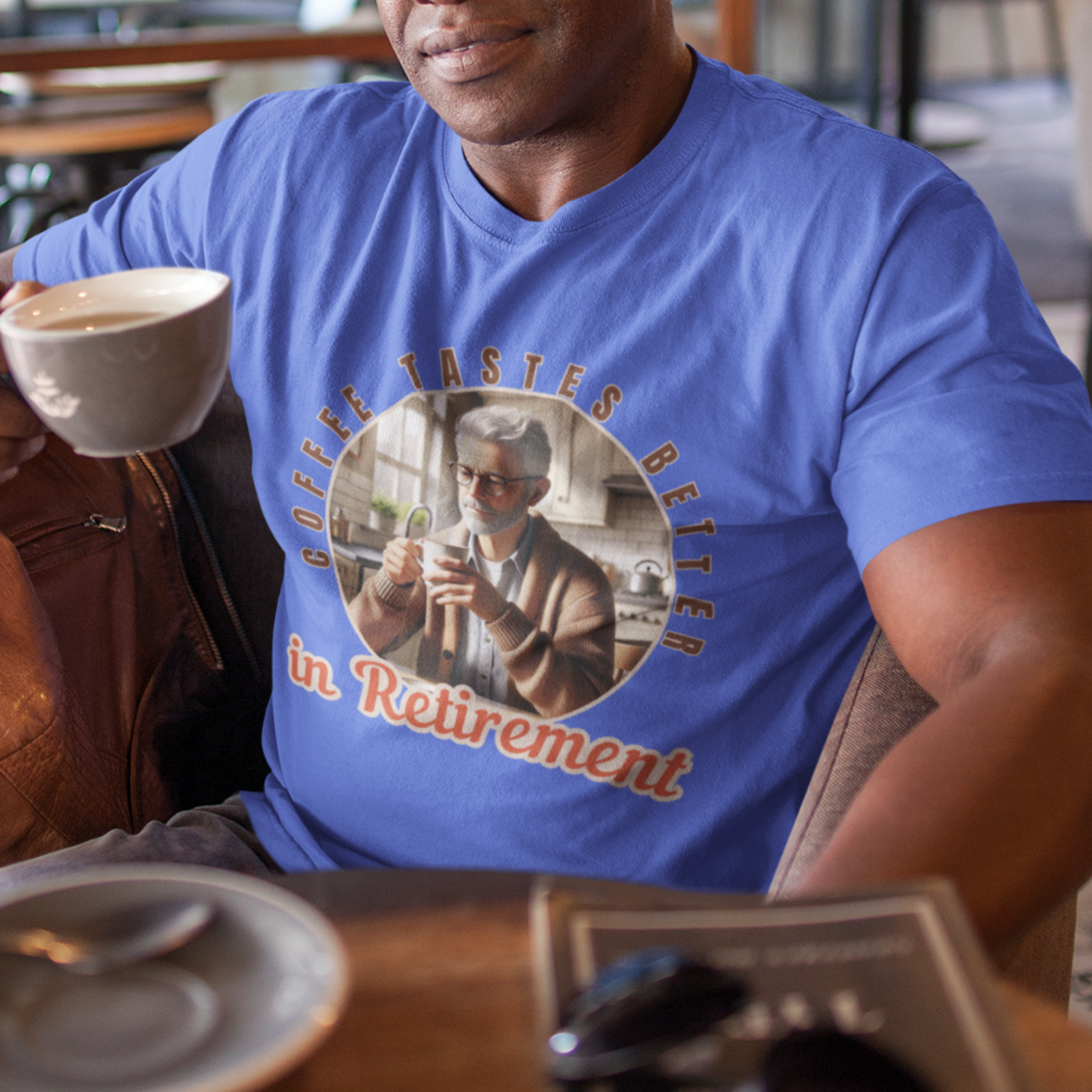 Royal blue tee featuring a senior man at his kitchen table enjoying a hot cup of coffee.