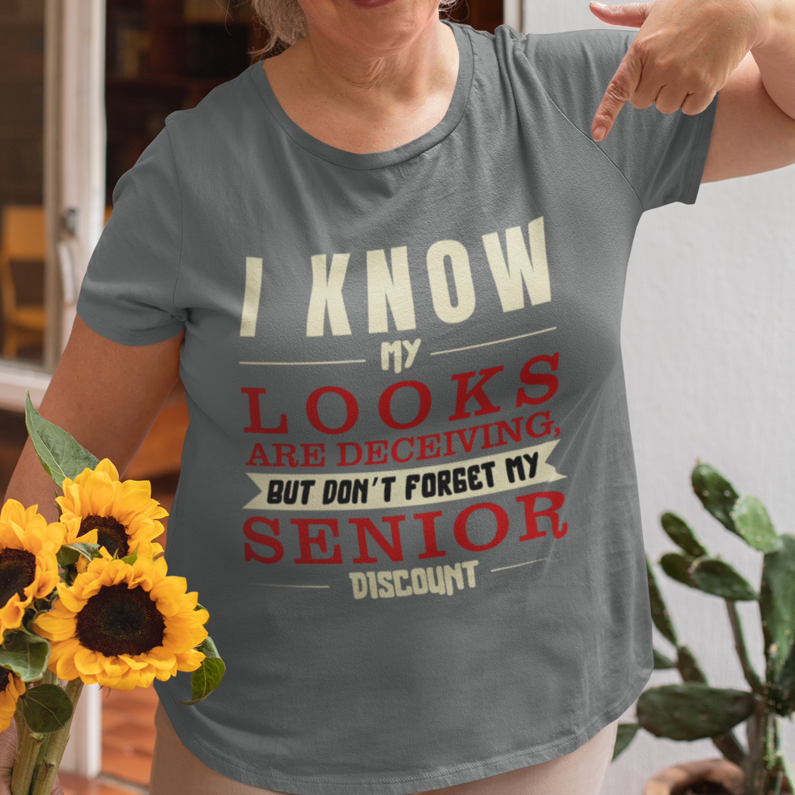 Heather gray t-shirt in bold, colorful lettering of alternating sizes about that senior discount.  