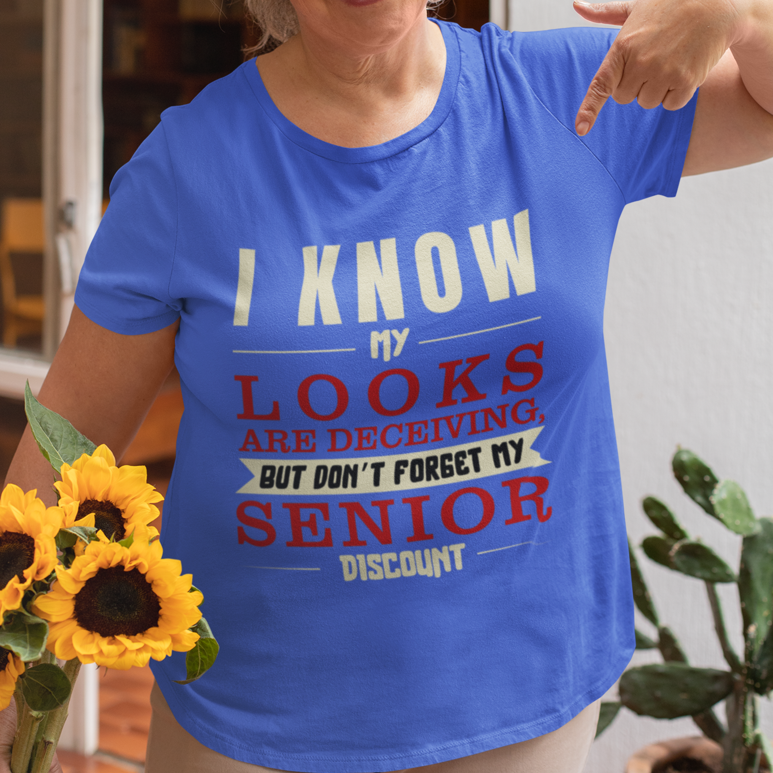 Royal blue t-shirt in bold, colorful lettering of alternating sizes about that senior discount.  