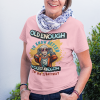 Light pink tee featuring an older woman in over the top fashion is full of attitude and lightheartedness