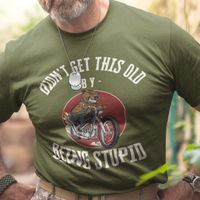 Military green t-shirt featuring a mean-looking cartoon grizzly on the back of a motorcycle blowing flames out the pipes.