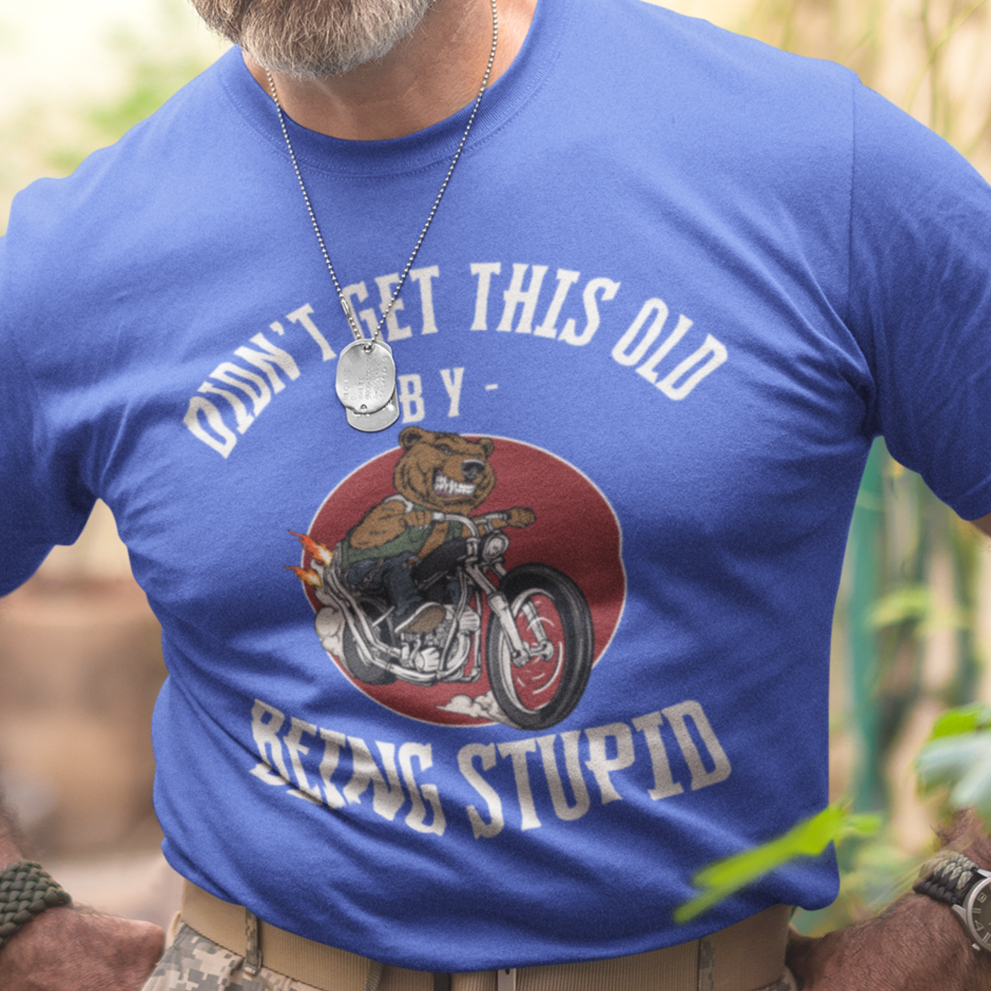 Royal blue t-shirt featuring a mean-looking cartoon grizzly on the back of a motorcycle blowing flames out the pipes.
