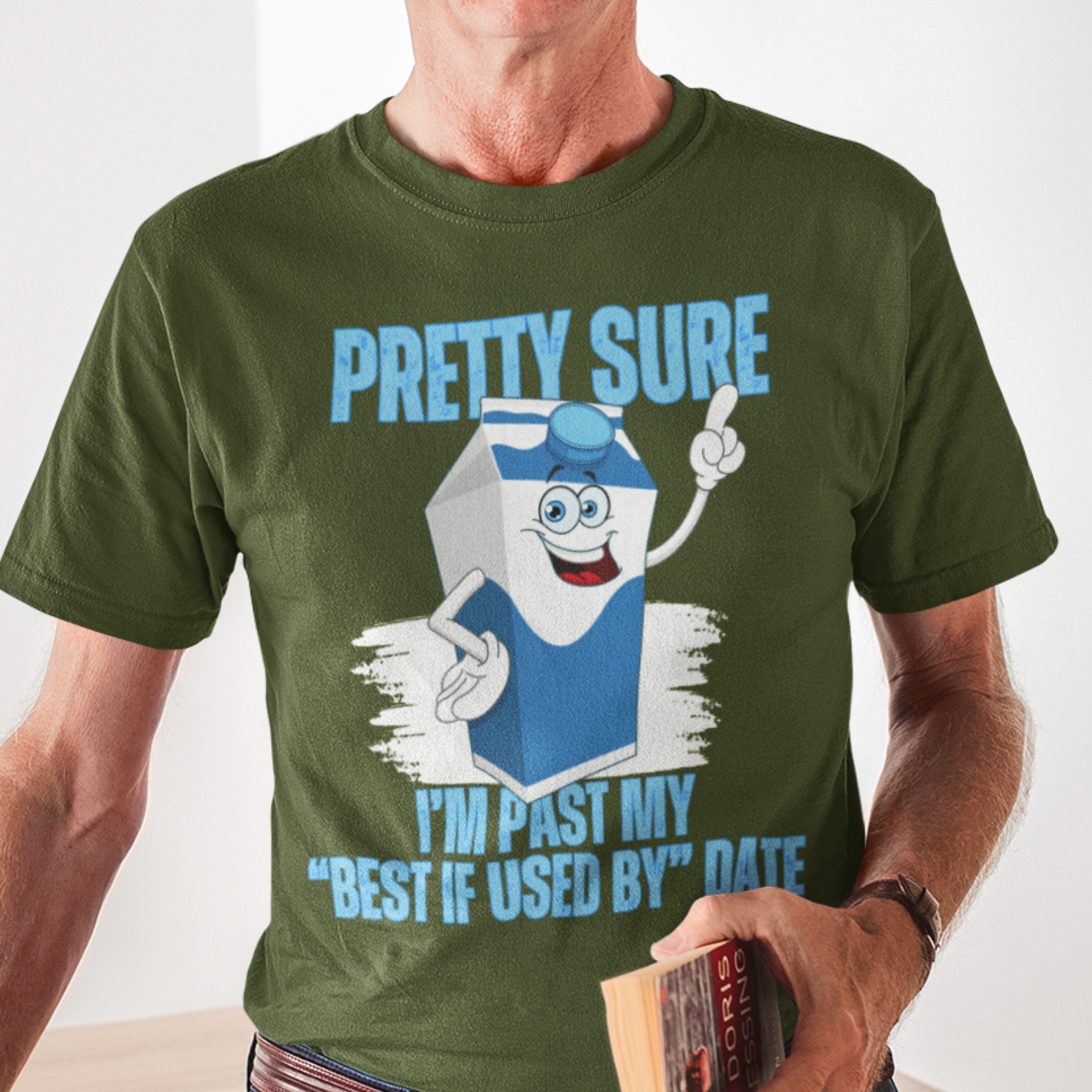 Military green t-shirt with neon lettering, featuring a cartoon carton of milk. 