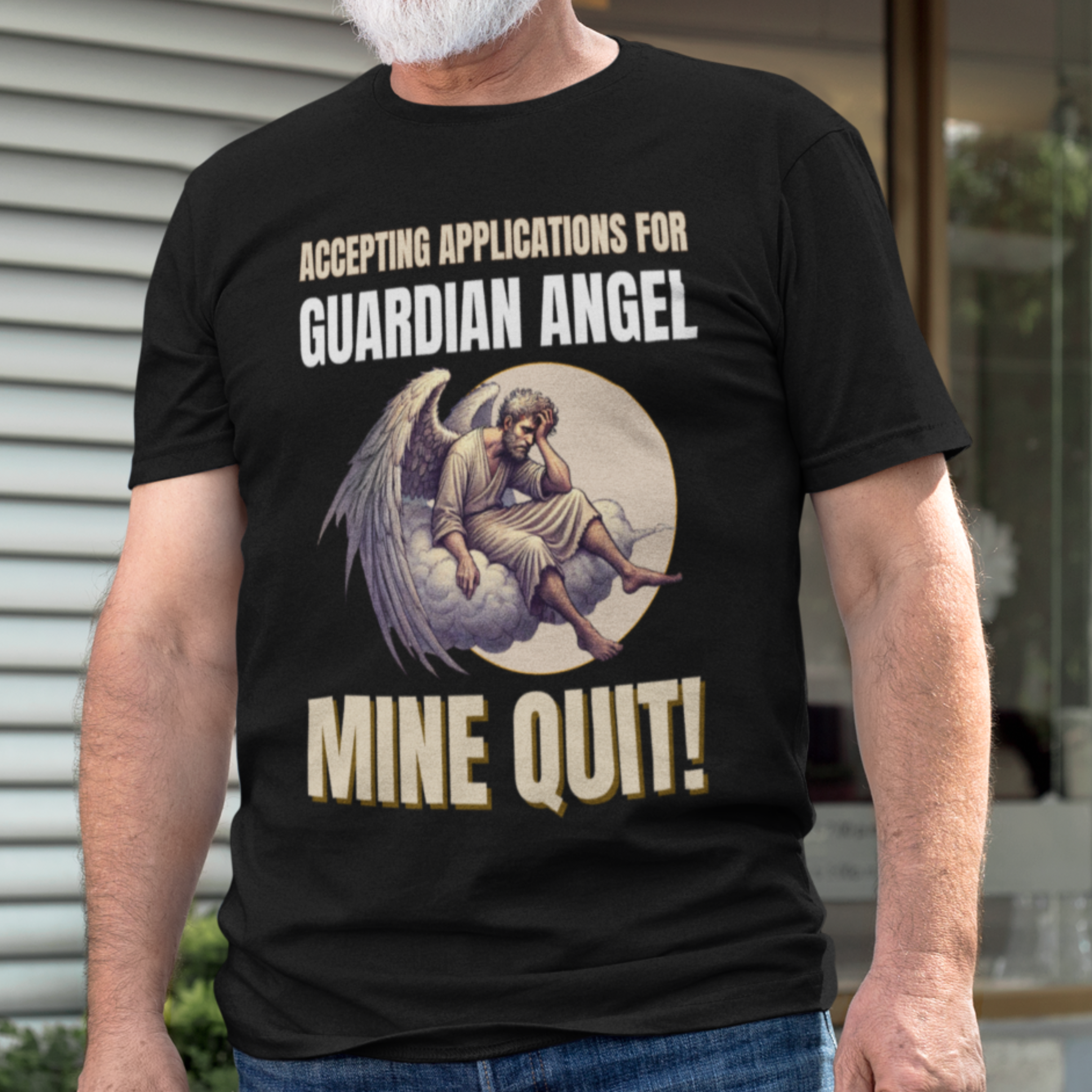Black t-shirt featuring a weary angel perched on a cloud with his head in his hand