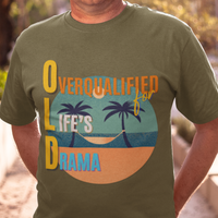 Military green tee featuring a hammock between two palm trees on a secluded beach, reading "OLD: Overqualified for Life's Drama"