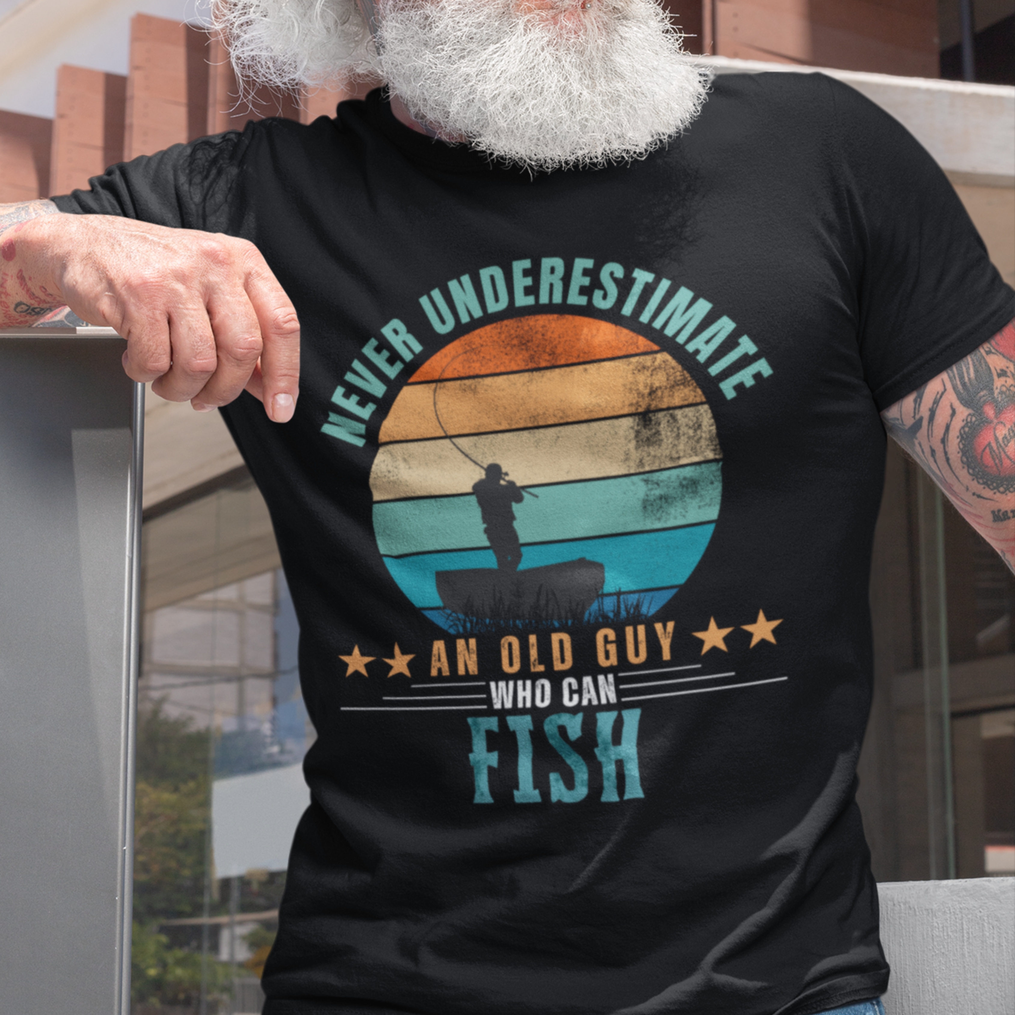 Black tee featuring silhouette of a fisherman in his boat cast against a stylish distressed striped sunset 