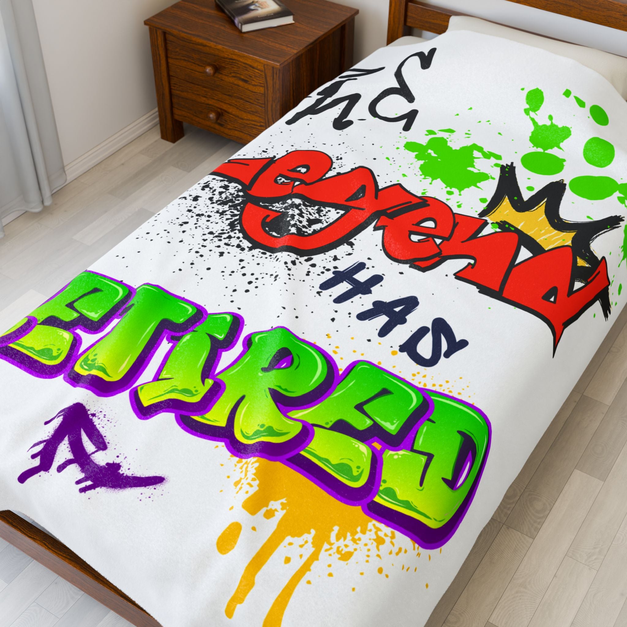 Colorful text and graphics on a 60X80 colorful blanket in a room that reads "The Legend Has Retired"