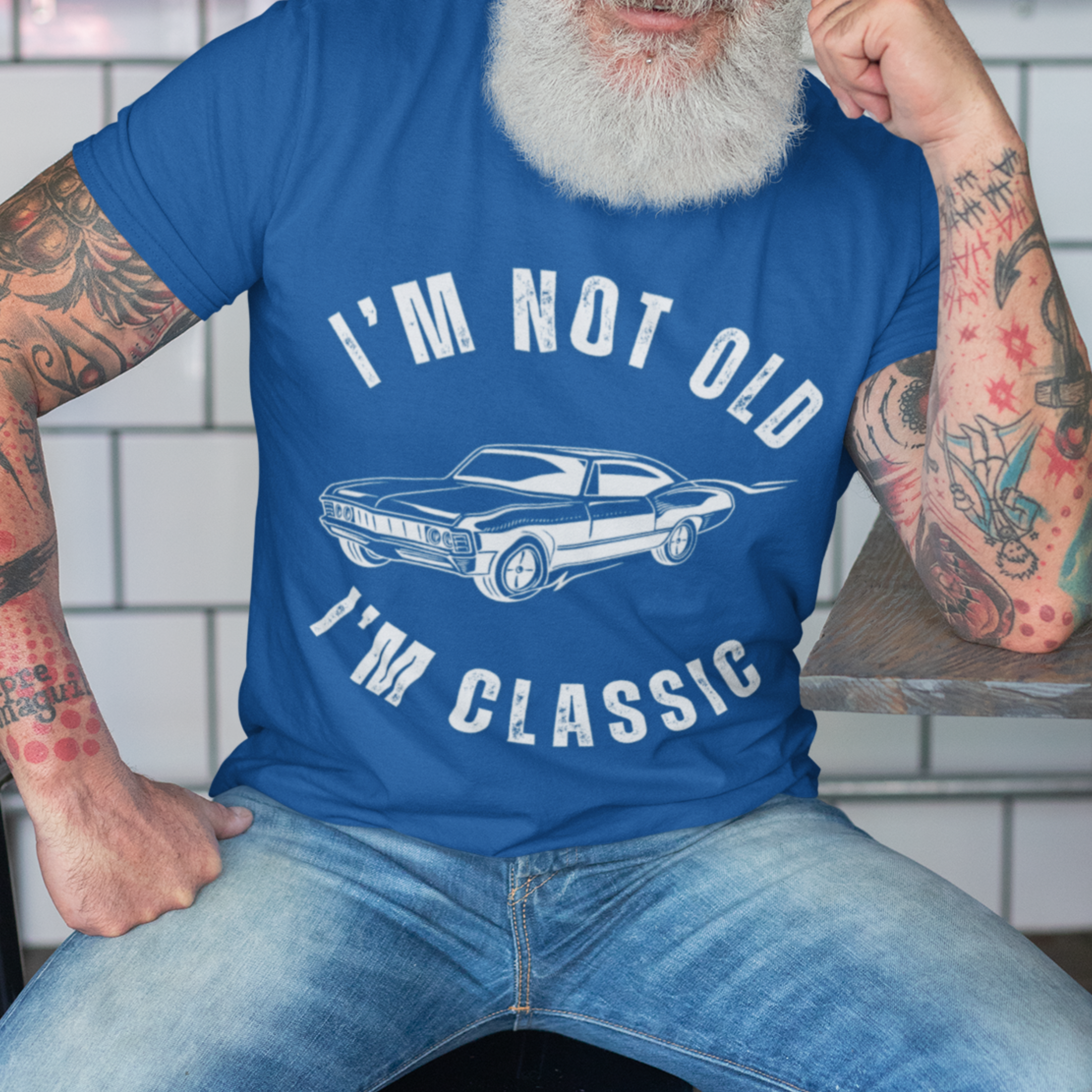 Royal blue tee featuring contour drawing of a 70s style muscle car 
