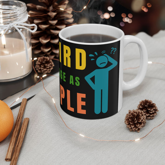 Mug with colorful text and graphics on a table with decorative items
