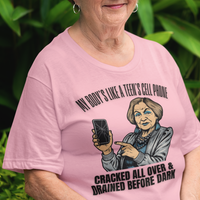 Light pink t-shirt featuring a cartoon older woman pointing to a broken cell phone 