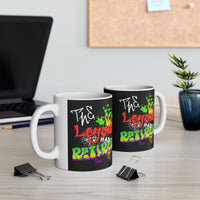 Two mugs with colorful text design on a desk with office items.